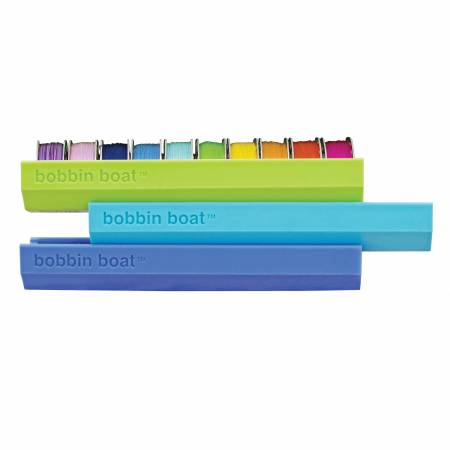 The Dritz Bobbin Boat is compact enough to slip into the side pocket of a rolling sewing machine tote or throw into a small sewing basket, all while keeping bobbins neat and tidy. Holds ten class 15 or class 66 bobbins.  Bobbins not included.  Made of: Plastic Use: Bobbin Storage Size: 1in x 4-7/8in Included: One Storage Boat