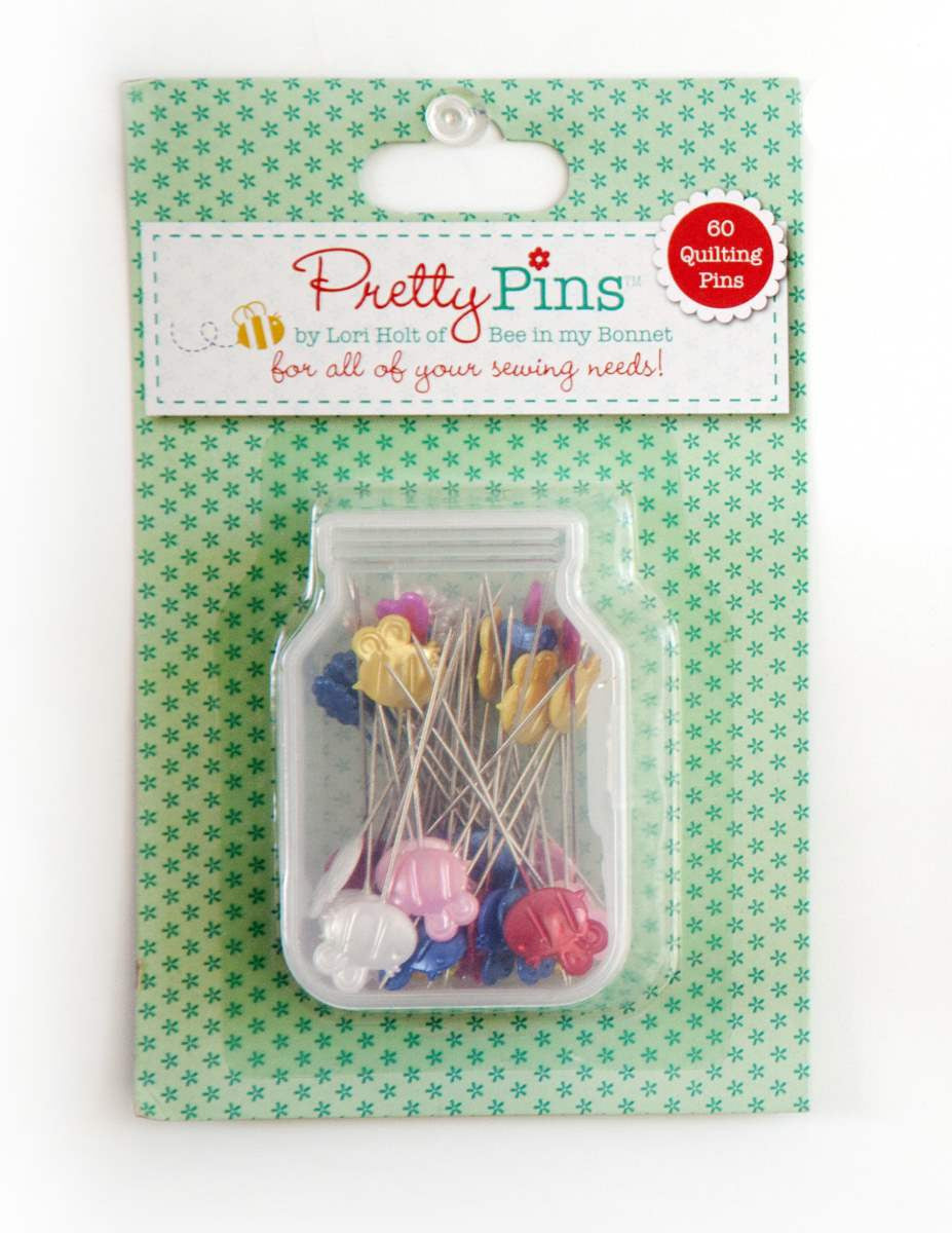 This package of Quilting Pretty Pins™ by Lori Holt of Bee in my Bonnet includes 60 super cute and colorful pins and comes in a cute little plastic mason jar container! These pins are extra long making them sew useful for pinning quilt blocks, sashings and borders. The adorable bumble bees, flowers, and hearts are so fun to have in your pincushion too. Put some whimsy and fun into your quilting by using these Pretty Pins!!