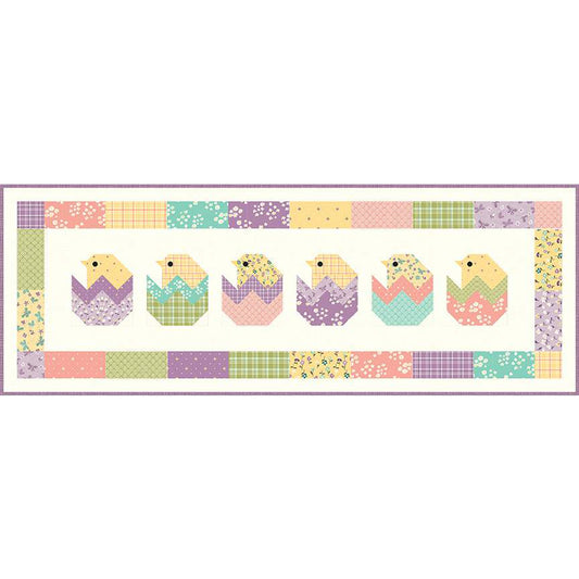 The Peeps Table Runner pattern by Sandy Gervais of Pieces from My Heart features is 5-inch stacker friendly and features pieced chicks hatching from their shells. Finished size is 15" x 42".